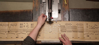Illustration for article titled These Scarves Are Woven Music, Made With Patterns From Organ Punchcards